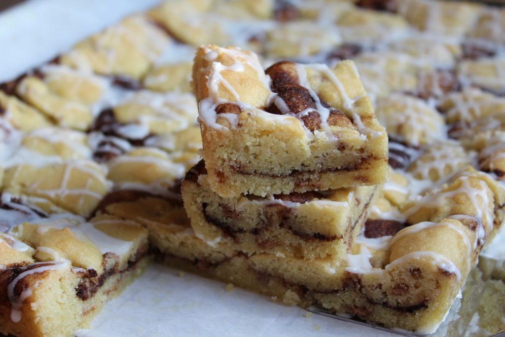 Cinnamon Chip Snickerdoodle Bars, side view, close up of cut bars on parchment paper