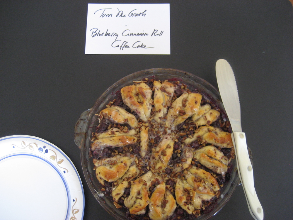  Tom McGrath, Editor, baked Marie Sheppard's   Blueberry Cinnamon Roll Coffee Cake  .  Mmm... this would be perfect for a relaxing weekend morning with a steaming cup of joe!  The cake was loaded with fresh blueberries which melded beautifully with the cinnamon and citrus flavors.  Toasty pecans topped off the dish and added a wonderful crunchy texture. 