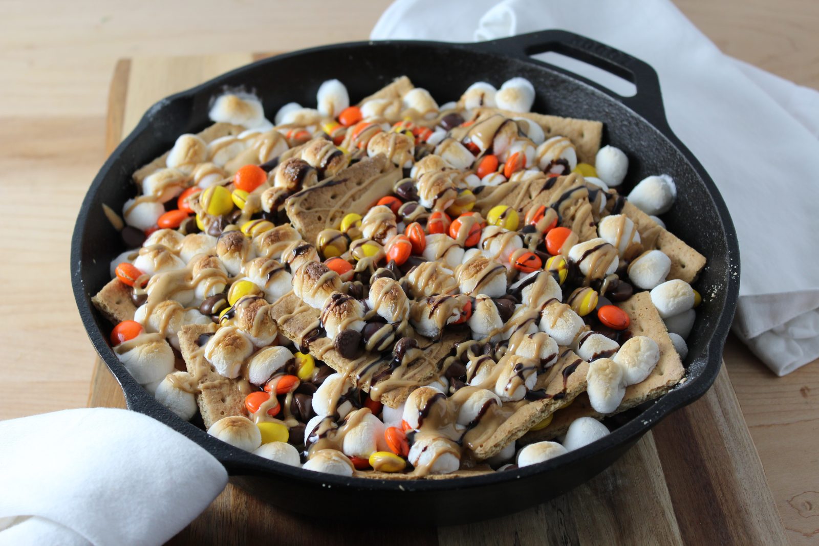 Peanut Butter Skillet S'mores Nachos - Baked and Drizzled with chocolate and peanut butter sauce