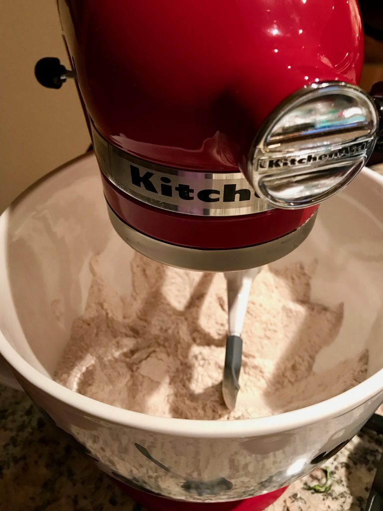 Yeasted Waffles: Mixing the dry ingredients in a red KitchenAid Stand Mixer with white ceramic bowl