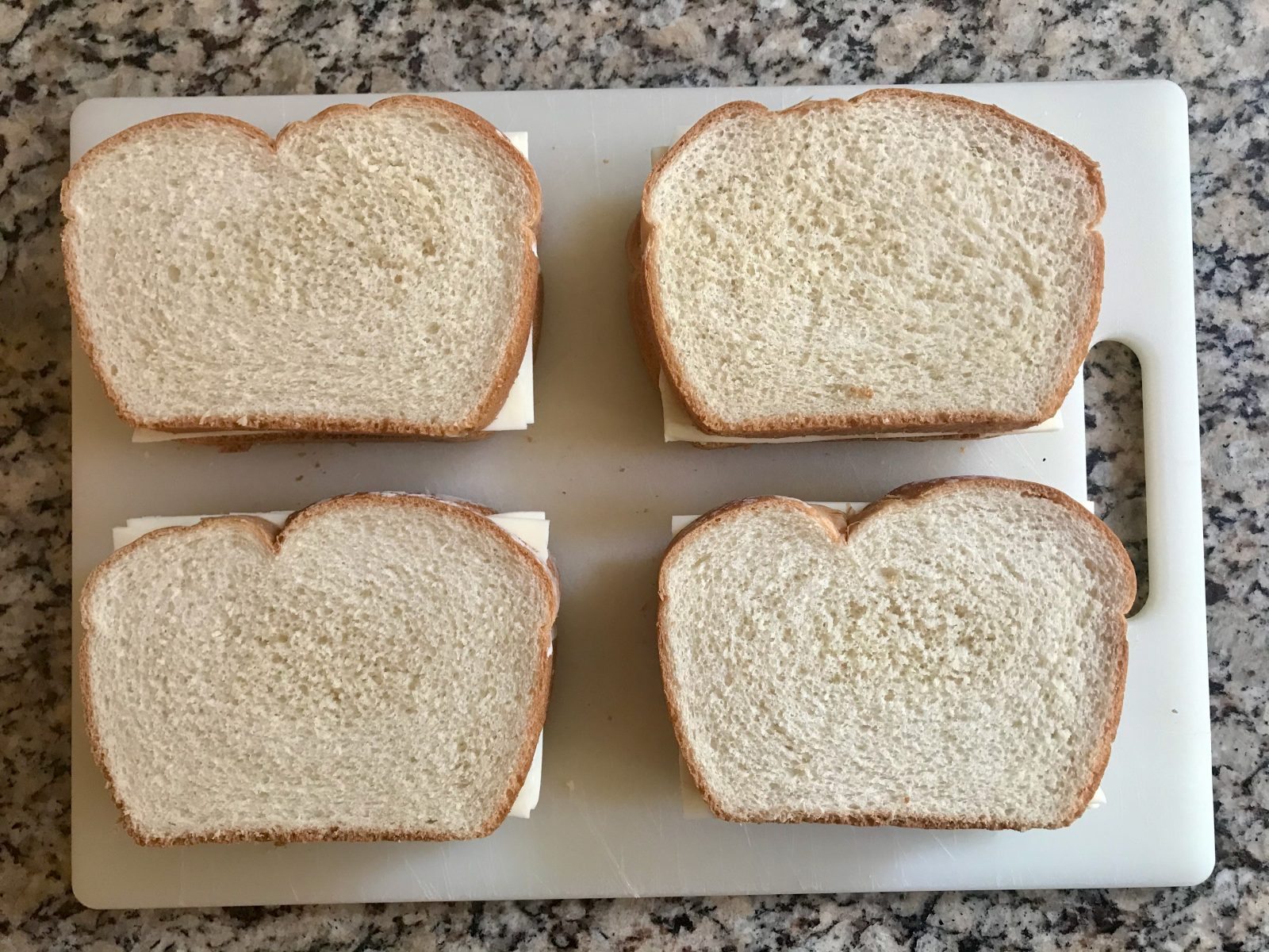 4 assembled uncooked gresilled cheese sandwich