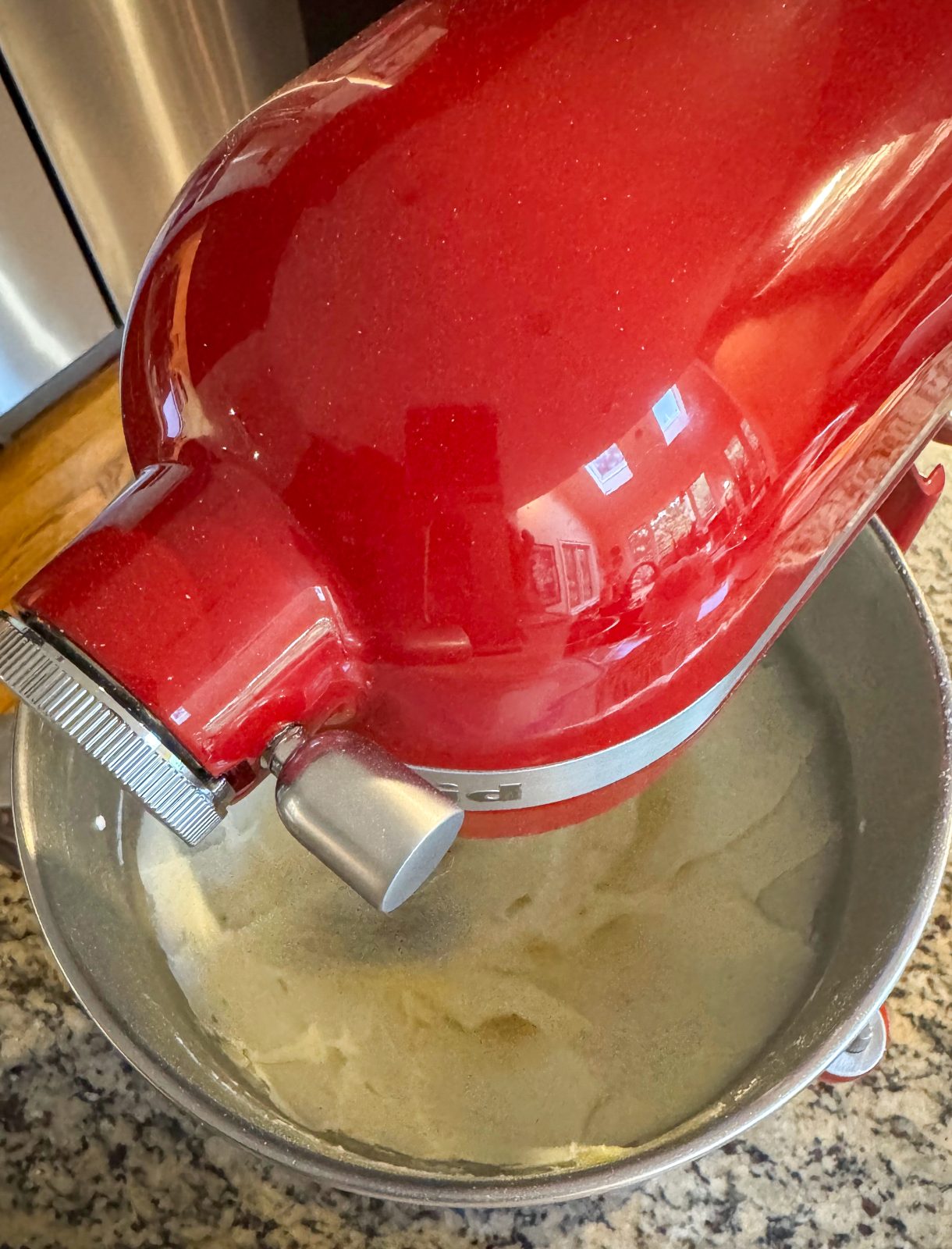 Recipe Photo for Less Sweet American Buttercream Frosting.  Red KitchenAid Stand Mixer creaming the butter and sugar mixture.