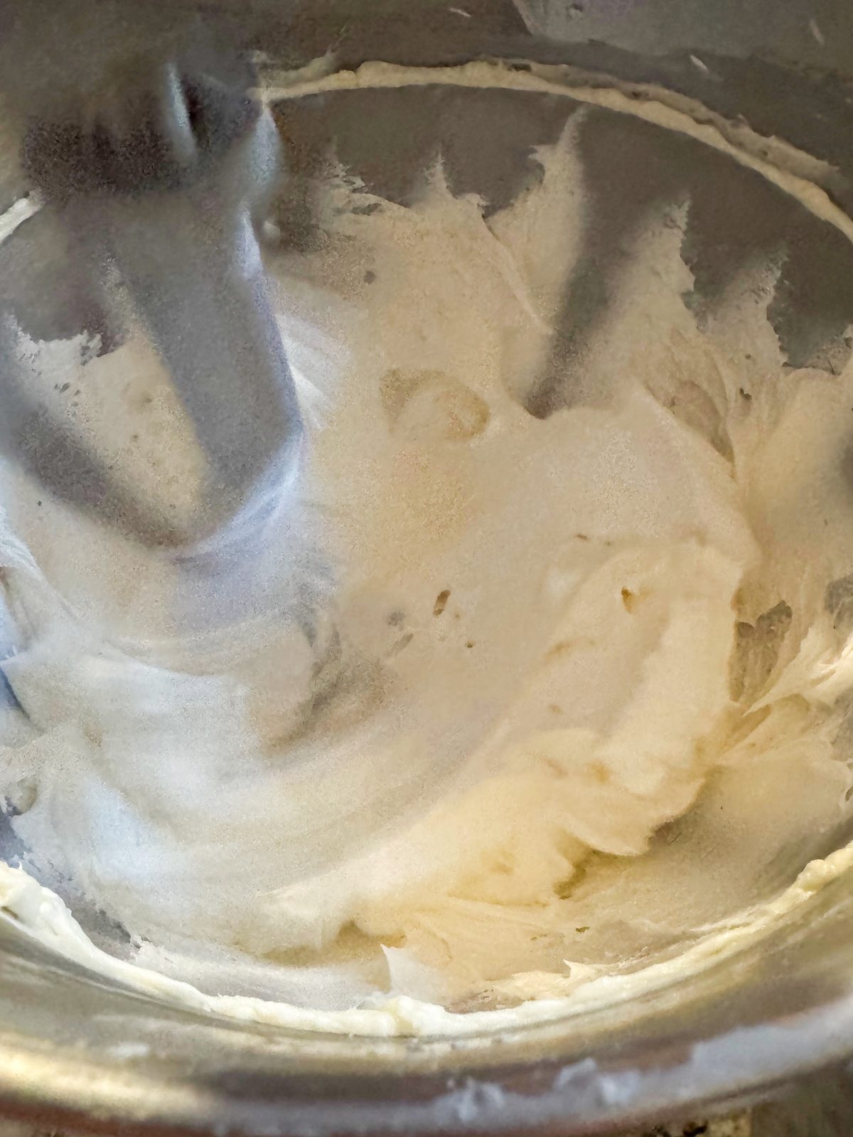 Recipe Photo for Less Sweet American Buttercream Frosting.  Mixing frosting in stainless steel stand mixer bowl.