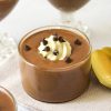 Finished Recipe Image of Cottage cheese chocolate pudding. pudding in a small straight sided glass dish with a dollop of whipped cream, mini chocolate chips and a gold spoon.
