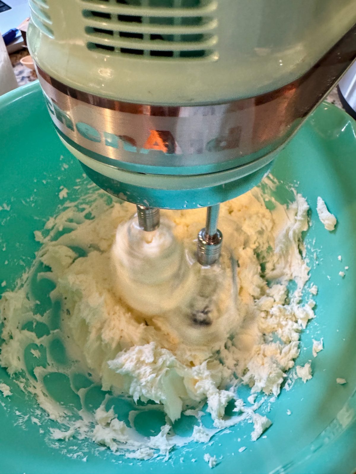 Recipe Photo for Red Velvet White Chocolate (Slow Cooker) Lava Cake. A ice blue KitchenAid Hand Mixer is mixing the cream cheese mixture in an ice blue mixing bowl.